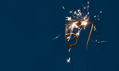 67 years anniversary celebration festive background made with Bengal fires in the form of number Sixty seven.