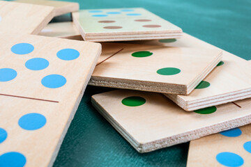 Wooden Domino Tiles With Colored Dots Stacked On Table