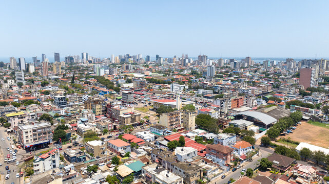 Aerial view of the city, where the buildings rise towards the horizon, a blend of modern and traditional architecture under the vast blue sky, Maputo, Cidade de Maputo, Mozambique.