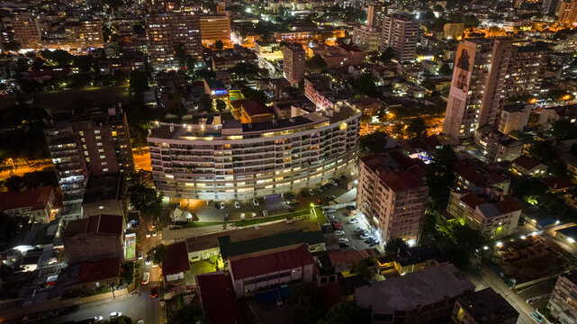 Aerial view of the lit buildings and streets creating a pattern of light and shadow, nestled in the heart of the vibrant cityscape, Maputo, Cidade de Maputo, Mozambique.