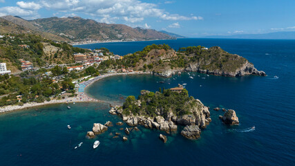 Obraz premium Aerial view of Isola Bella, a tidal island located on the eastern coast of Sicily, in province of Messina, Italy. It's a wonderful summer tourist destination.On the horizon, it's the Mediterranean Sea