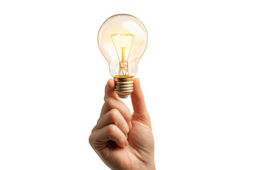 A hand holding a glowing light bulb in darkness