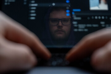 Man Reflection on Laptop Screen with Typing Hands.