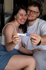 Happy Couple Celebrating Positive Pregnancy Test Portrait