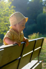 Toddler in Sun Hat at Park Bench Portrait
