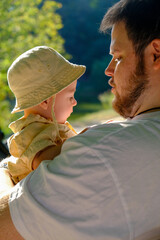 Father and Baby Relaxing in Sunny Park Copy Space