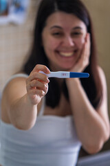 Surprised Woman with Positive Pregnancy Test