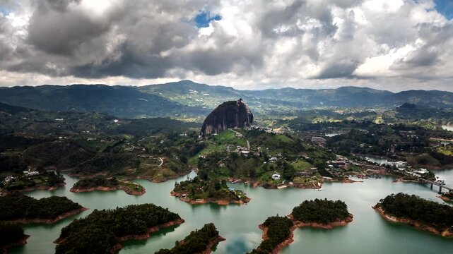 Drone hyperlapse view of clouds flying over El Penol landmark inselberg, Guatap&eacute;