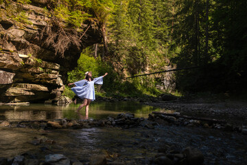 Woman Strolling by River in Forest Copy Space