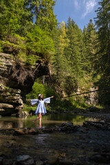 Woman Strolling by River in Forest Copy Space