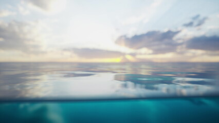 Fototapeta premium Soft waves gently ripple on the ocean surface as the sun sets in the distance. The sky glows with hues of orange and pink, creating a serene atmosphere at twilight.