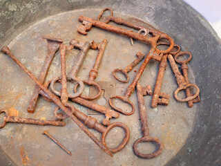 Antique flea market in Europe, Italy. Vintage items. Set of rusty iron keys. Retro items for background decoration.