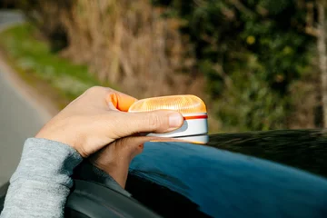 Fotobehang Natuur Park a man places a V16 warning beacon on his car roof  © nito
