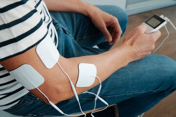 electrode pads attached to the arm of a man