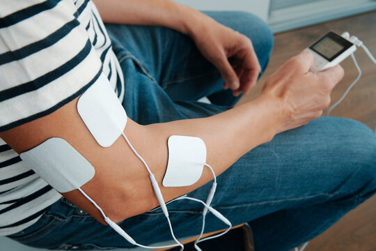 electrode pads attached to the arm of a man