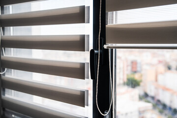 Close-up of zebra roller blinds fabric texture on window with adjustable light control in modern...