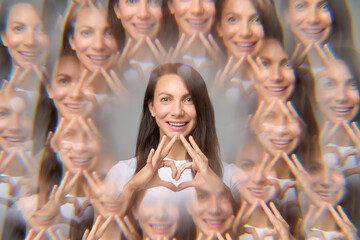 Surreal creative portrait of woman making heart shape with fingers 