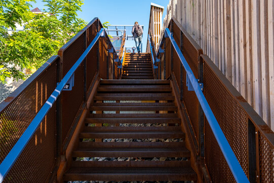 Outdoor urban architecture staircase with stairs and handrail showing wood and metal lines and strong perspective in clean modern design