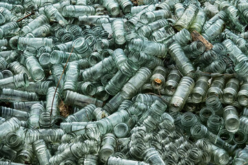 Empty glass sauce jars (industrial glass container) piled high, production has stopped, production slump, non returned empties concept. Jars background