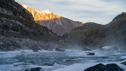 a beautiful mountain river in a snowy gorge. highlands. winter in the mountains