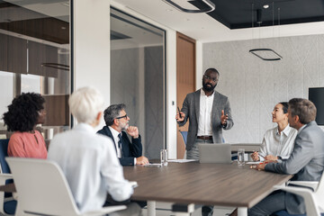 Black entrepreneur presenting business strategy to diverse team