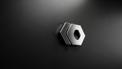 A metallic hexagonal logo with sharp edges is embossed on a textured black surface, casting a subtle shadow