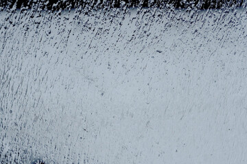 Water streaks and raindrops on glass surface. Abstract cold blue background with wet texture, rainy...