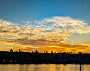The yellow and orange shadows of sunset clouds. Dramatic high-altitude backdrops of gold textured cloud. Panorama volumetric light shadow, glowing deep contemplation. Majestic scenery light.