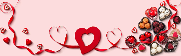 Valentine's Day Heart Decorations and Chocolates on Pink Background with Red Ribbon, banner