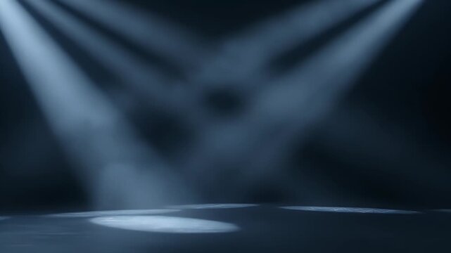 Dynamic beams of bright, cool white light cut through a misty, dark environment, creating a dramatic and atmospheric spotlight effect on an empty stage or floor. The light rays shift and converge, hig