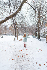 Cheerful female walking outdoors after snowfall winter mood healthy lifestyle and urban nature
