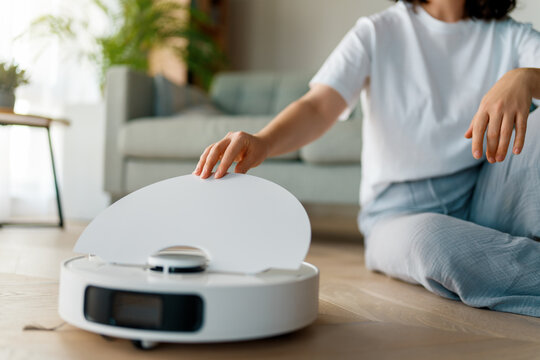 White robotic vacuum cleaner on wooden floor