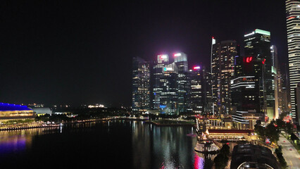 Stunning aerial nighttime panorama featuring the Merlion statue, Jubilee Bridge, and Marina Bay area