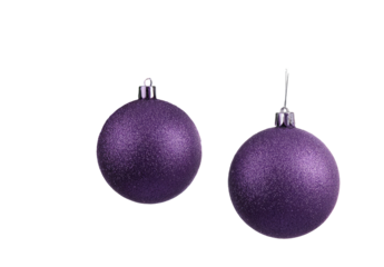 Two frosted purple Christmas ornaments with silver tops, hanging, against black