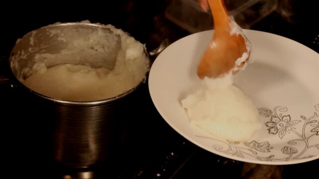 Corn or maize flour pap, a staple food in many countries in Africa being served in a round scoop