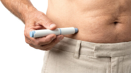Man injecting insulin or semaglutid pen into abdomen to administer diabetes medication