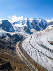 Piz Palu rises high above the stunning Pers Glacier, showcasing rocky ridges and snow-capped peaks...
