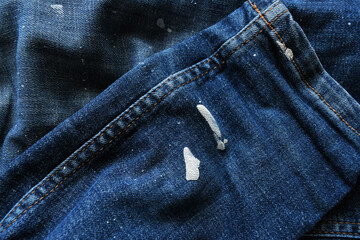 Dirty jeans with paint stains. How to clean jeans concept.