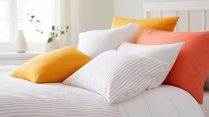 Soft pillows arranged on a bed create a cozy and inviting atmosphere in a bedroom