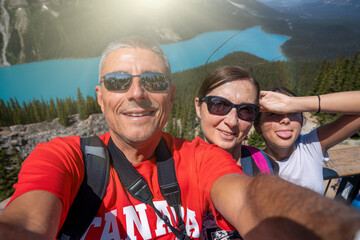 Happy family enjoying Peyto Lake viewpoint during sunny summer day in Banff National Park