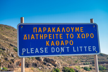 Environmental awareness sign in Santorini urging visitors to dis