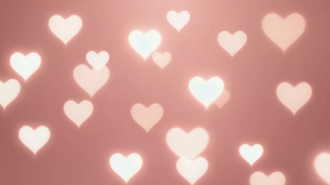 Glowing heart shaped bokeh lights on a soft rose gold panoramic background. Festive and romantic design for a wedding invitation, valentine's day card or website header