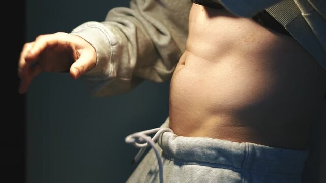 A person with an itchy body is wearing oversized pants.
Motivation to exercise.
An active and athletic lifestyle.
A person pulls down their secret sweatpants and shows off their workout results.