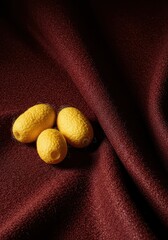 Luxurious textured fabric sample displayed next to raw silk cocoons, symbolizing renewed interest in high-quality textile production and heritage crafts, industry, collection, spool