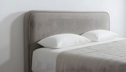 Elegant modern bed with plush gray headboard and crisp white linens