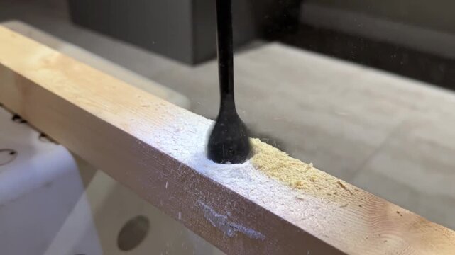 Close-Up View of a Power Drill in Action on Wooden Surface for DIY Home Improvement Projects