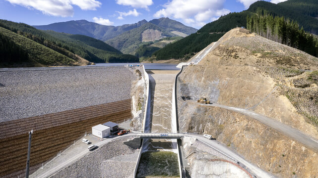 Lee Valley, New Zealand - 24 January 2024: Aerial view of the dam's stark concrete against the rugged hills, a testament to engineering amidst nature's grandeur.