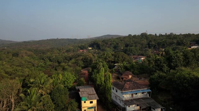 Ariel shot of village low drone backwards with coconut trees 