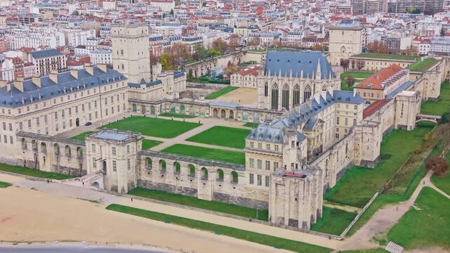 Aerial drone view of the historic Chateau de Vincennes, including the keep and Sainte-Chapelle. Lawns surround the medieval fortress. Ideal for French history and architecture, France