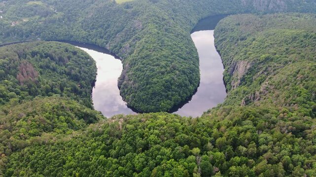 Drone flies forward then tilts down, Vltava meander at viewpoint, Czechia